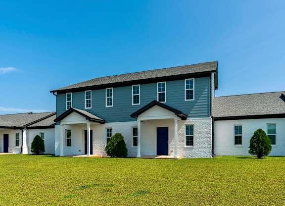 a house with blue siding and a gray roof