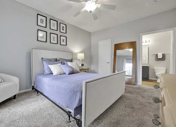 Primary bedroom with ensuite bathroom at Village at Caldwell Apartments in Birmingham, AL