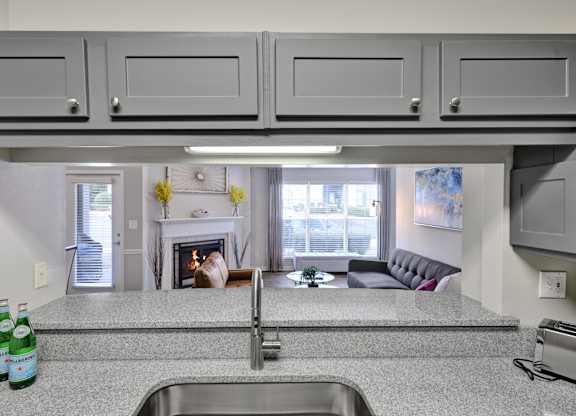 Kitchen with granite countertops and gooseneck faucet at Village at Caldwell Apartments in Birmingham, AL