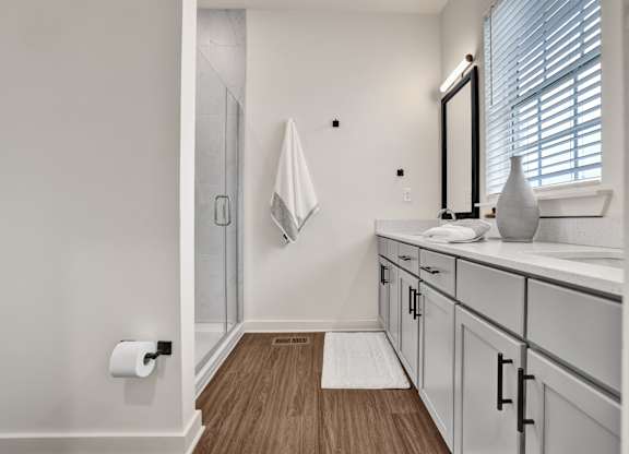 Bathroom with double vanity and quartz countertops at West Row Lofts and Townhomes in Birmingham, AL