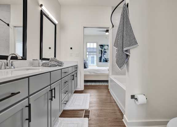 A bathroom with a checkered towel hanging on the wall.