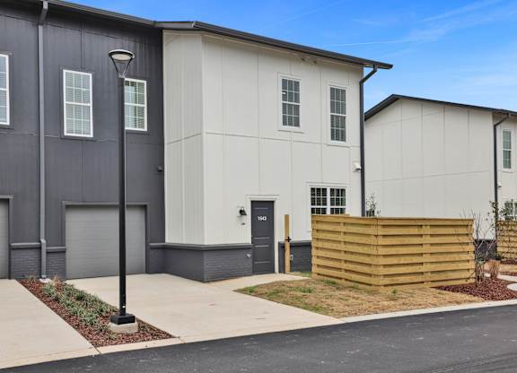 A modern two-story townhouse with fenced pet yard at West Row Lofts and Townhomes in Birmingham, AL