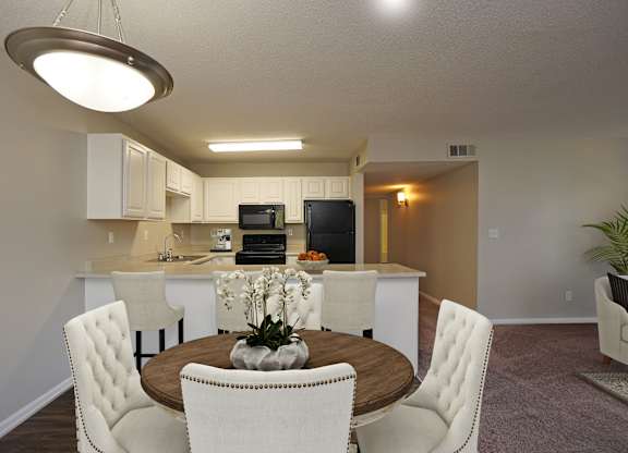 A modern kitchen with a dining table and chairs.