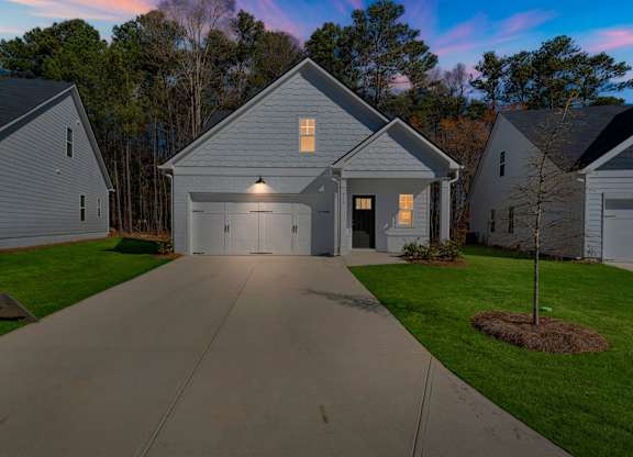 A house with a driveway in front of it.