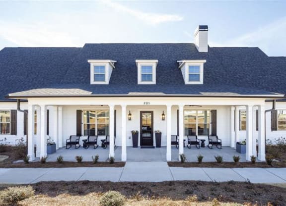 a white house with pillars and a covered porch