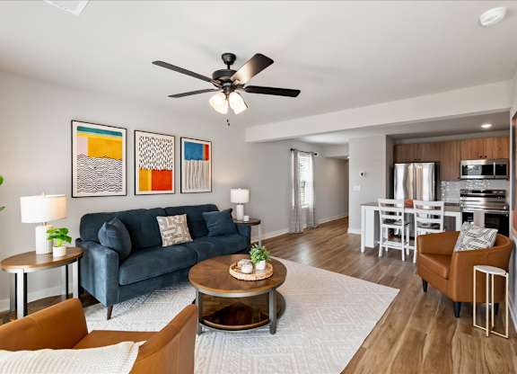 A living room with a blue couch and a coffee table.
