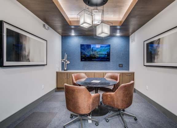 A conference room with a table and chairs.