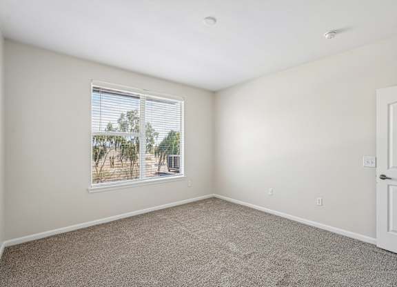 A room with a window and a door.