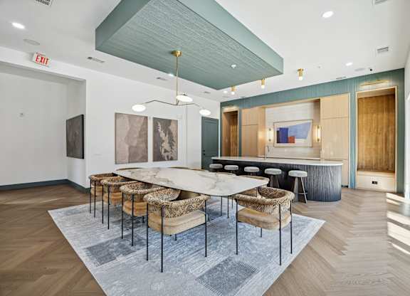 A conference room with a long table and chairs.