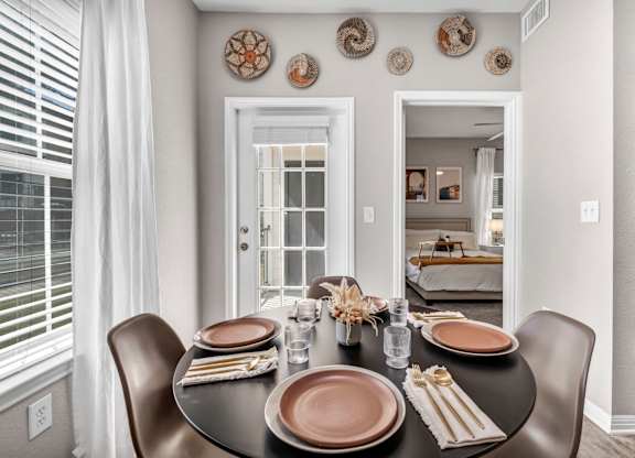a dining room with a table and chairs