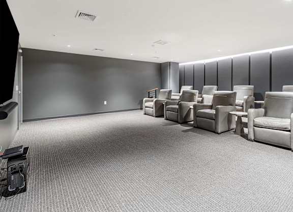 a waiting room filled with chairs and a tv