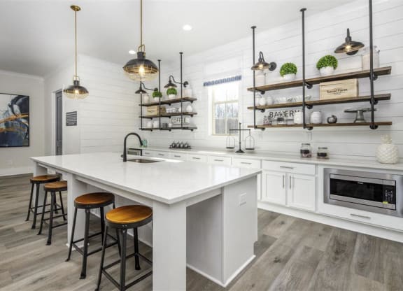 a kitchen with a large white counter top