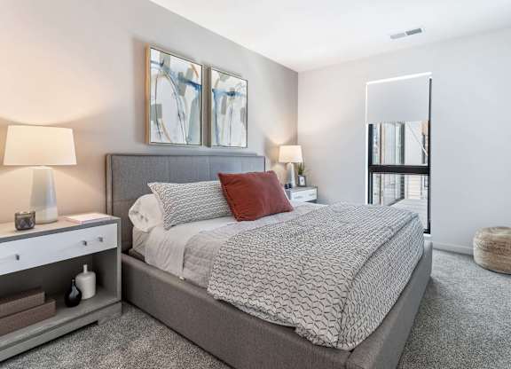 a bedroom with a large bed and a mirror