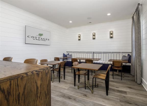 a dining room with tables and chairs and a bar