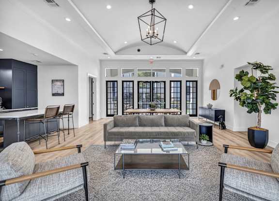 a living room filled with furniture and a large window