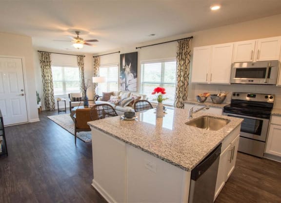a kitchen and living room with a granite counter top