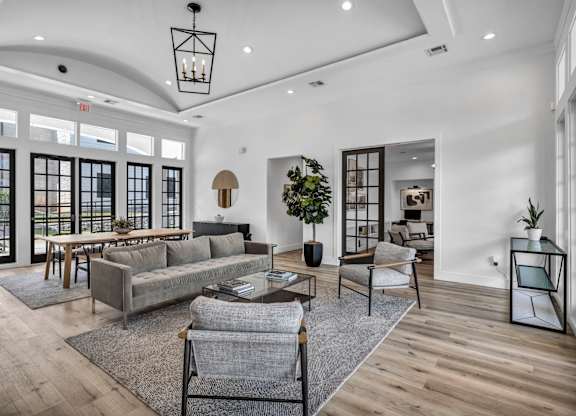 a living room filled with furniture and a large window