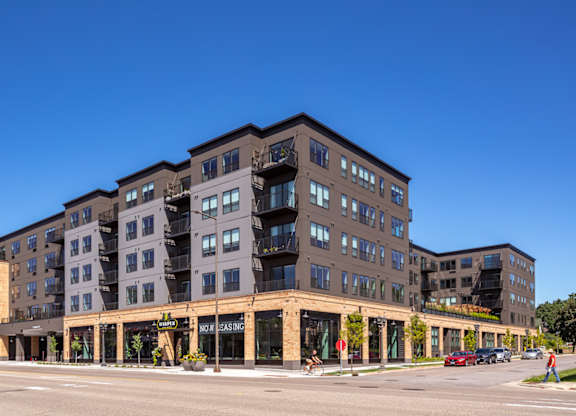 a large apartment building with a street in front of it at Harper Apartments in St Paul, MN