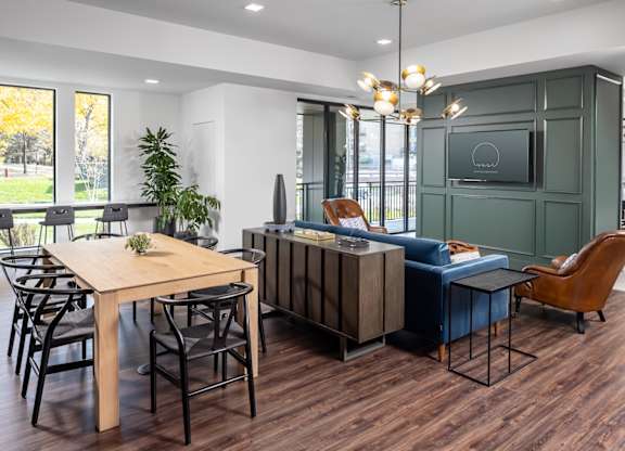 a dining room and living room with a table and chairs