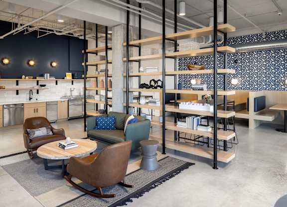 the lobby of a furniture store with chairs and tables