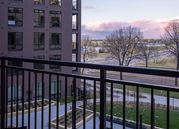 a balcony with a view of a building and a fence