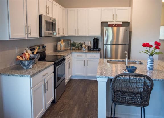 a kitchen with white cabinets and a glass floor