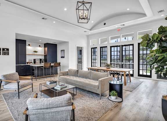 resident clubroom filled with furniture and a large window
