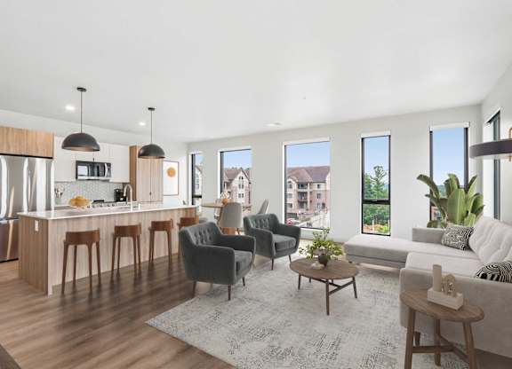 A modern kitchen with a dining area and a living room.