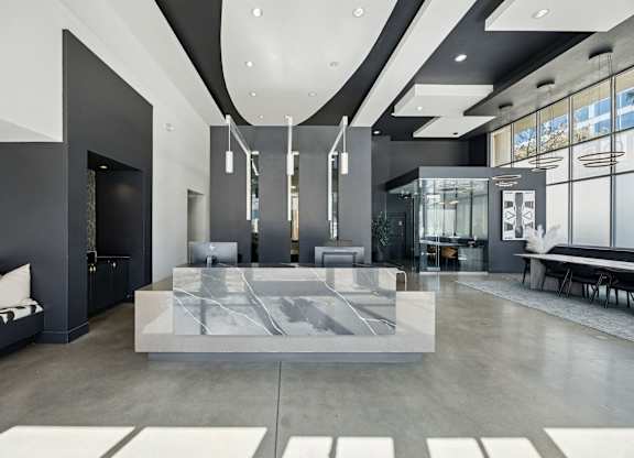 A modern living room with a marble coffee table and a black and white sofa.