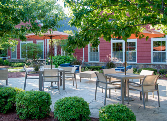 Outdoor patio seating with lush landscaping