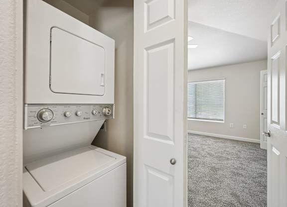 A white washing machine and dryer in a small laundry room.