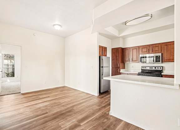 A kitchen with wooden cabinets and a white counter.
