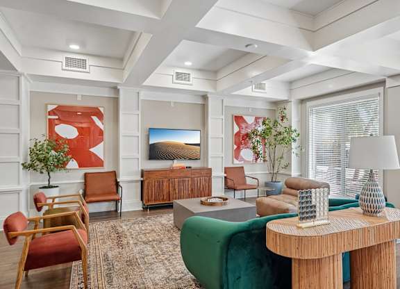 A living room with a green sofa and a wooden coffee table.