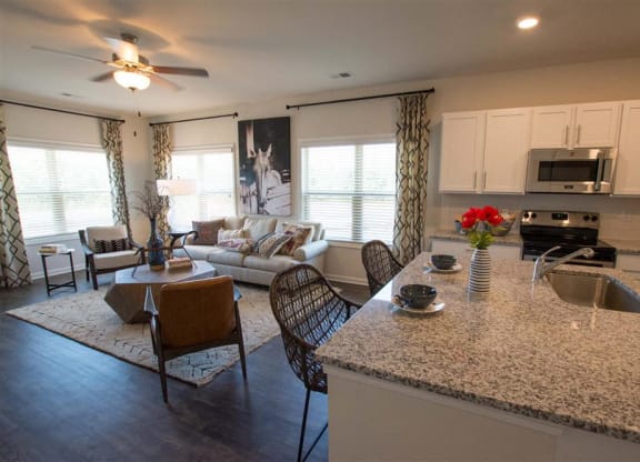 a living room with a kitchen and a table