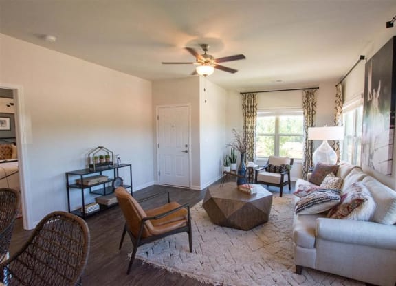 a living room with a couch and a ceiling fan