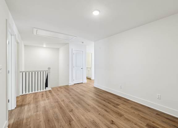 A room with wooden floors and white walls.