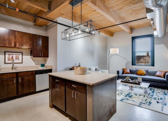 Lofts open living area with exposed beams and ducts C&E Living in St Paul, MN