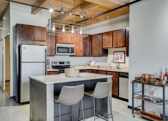 Loft style kitchen with exposed C&E Living in St Paul, MNbeams
