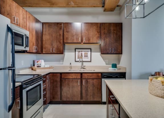 Lofts kitchen with industrial style lighting and exposed beams C&E Living in St Paul, MN