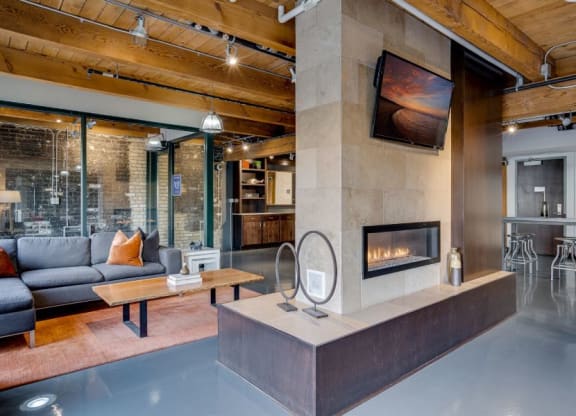 Urban industrial lobby with exposed wood and brick in historic building C&E Living in St Paul, MN