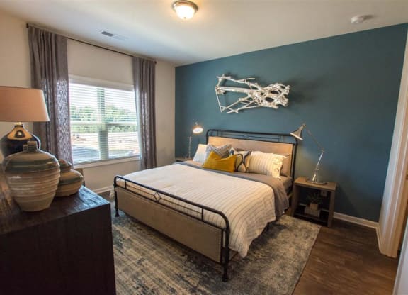 a bedroom with a bed and a blue accent wall