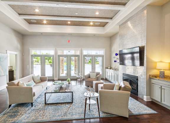 a living room with couches a coffee table and a fireplace
