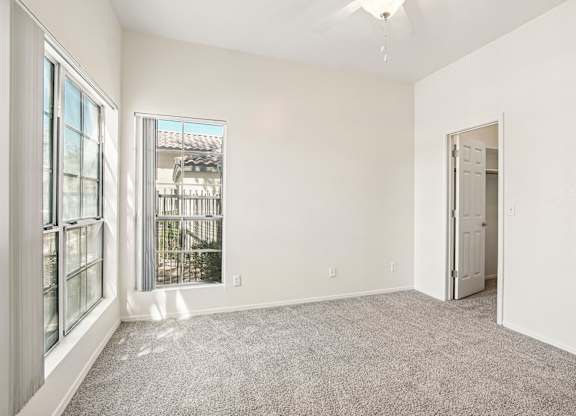 A room with a grey carpet and white walls.