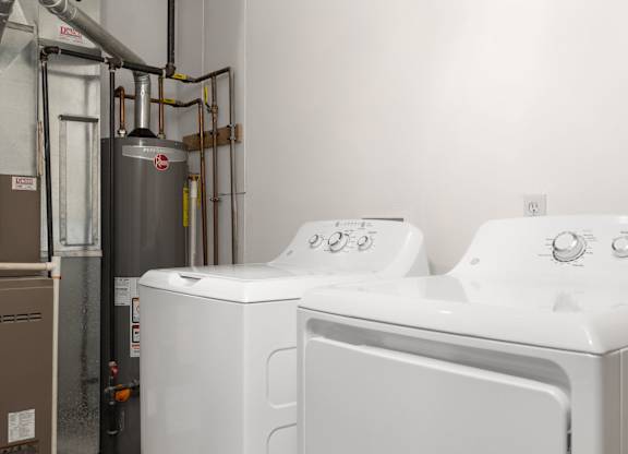 A washing machine and dryer in a laundry room.