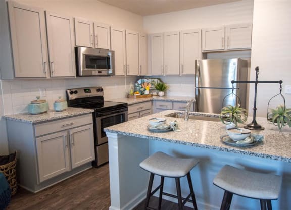 a kitchen with granite counter tops and stainless steel appliances