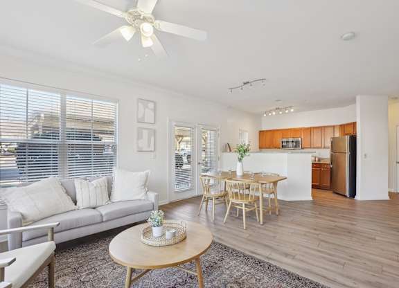 A living room with a grey couch and a wooden table.