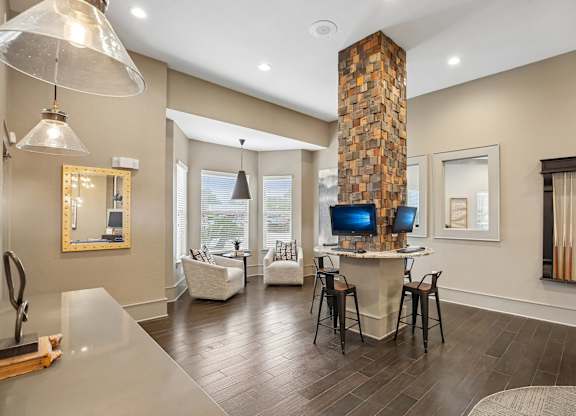 A modern living room with a stone fireplace and a television.