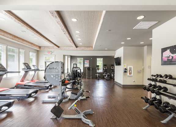 a spacious fitness center with treadmills and other exercise equipment