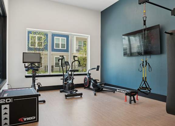 A room with exercise equipment and a window.