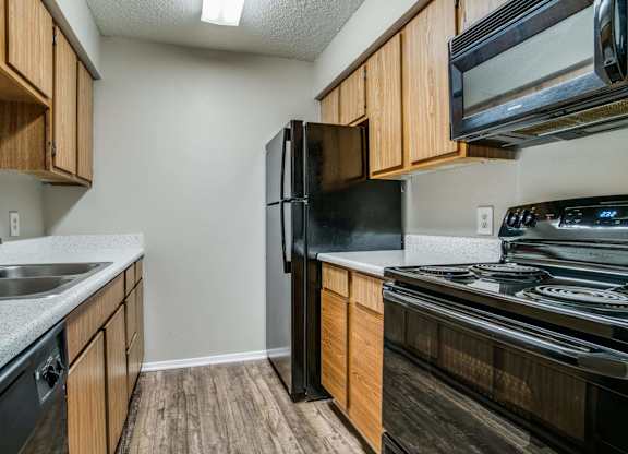 the kitchen of a home with a stove refrigerator and sink